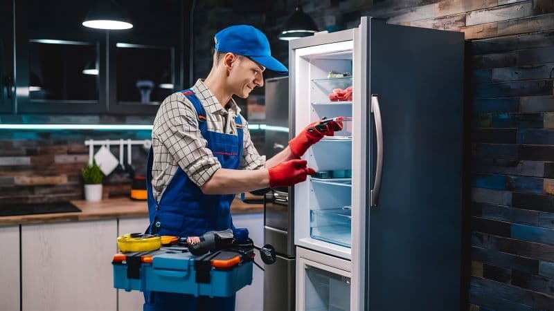Refrigerator technician repairing refrigerator