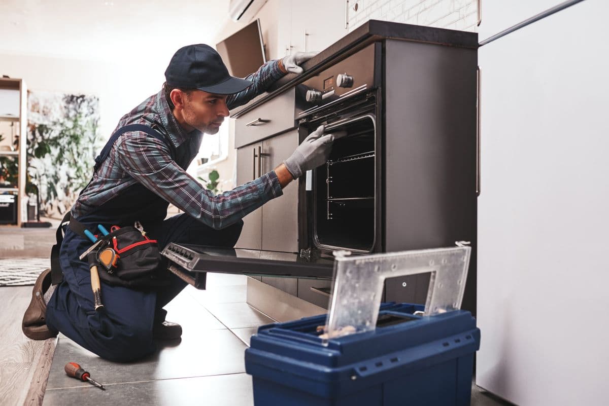 Technician repairing fridge