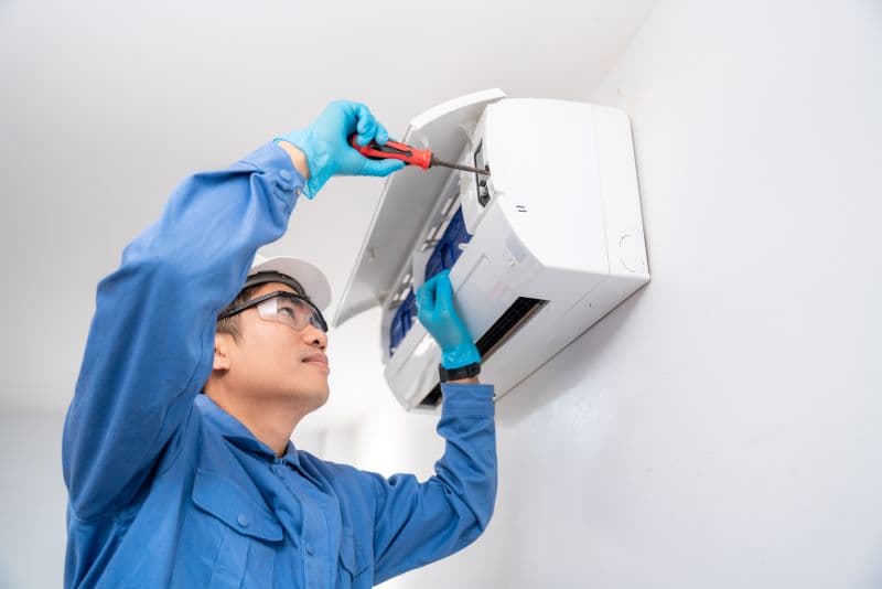 AC technician repairing air conditioner